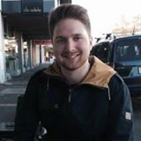 Lauri Timmanee wearing a blue jacket on a street with cars in the background
