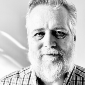 black-and-white photo of Eric Michalsen in a checked shirt