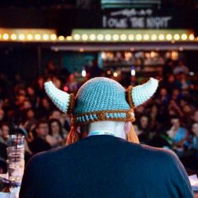 Hilmar Hallbjörnsson from behind wearing a viking hat